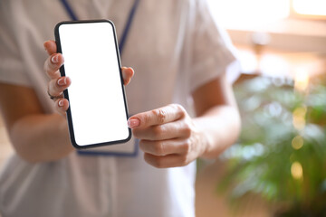 Woman using mobile phone in office, closeup