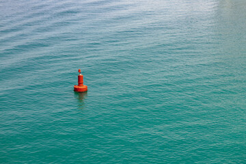 Single red buoy in the clear sea