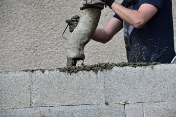 Detail of a concrete pump from which concrete is poured into walls on the construction site