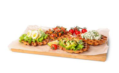 Delicious Belgian waffles with vegetables on white background