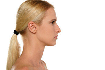 Profile of young blond woman without makeup, and with tied hair