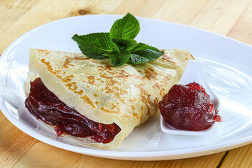 Delicous pancake with fruit jam