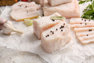 Parchment with salted lard on light background