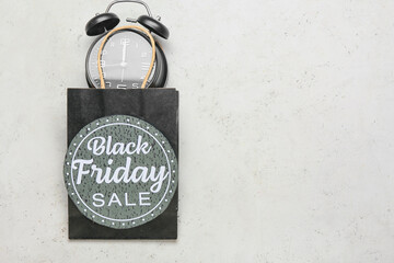 Shopping bag, clock and card with text BLACK FRIDAY SALE on light background