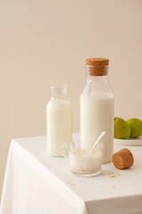 Obraz na płótnie Canvas glassware of milk and fruit oatmeal on table.