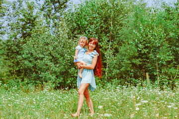 Fototapeta premium mom hugs her daughter in nature