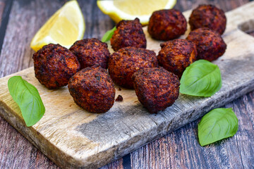 Home made deep fried   mini  fish and vegetables meatballs ,on  rustic background