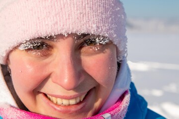woman with frost eyelashes on a frosty winter day, outdoors