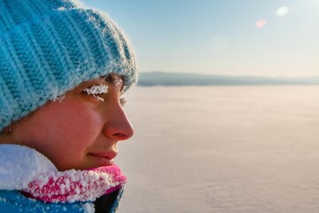 woman with frost eyelashes on a frosty winter day, outdoors