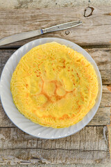 Bakery. Home made pancakes with   organic free range  eggs and white cheese on wooden background. Rustic style breakfast