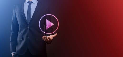 Businessman pressing, hold play button sign to start or initiate projects.Video Play Presentation. Idea for business, technology.media player button. Play icon.Go.