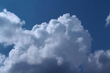 Naklejka na ściany i meble Blue sky with a big cold bizarre cloud sunny day. Only the sky and cloud.