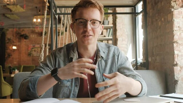 Young professional man using web camera