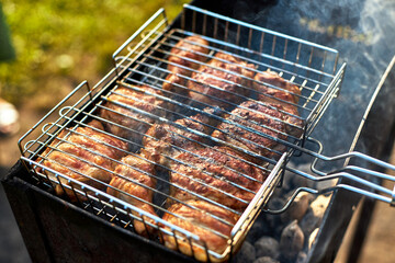 Barbecue chicken on the grill is fried on the grill with smoke