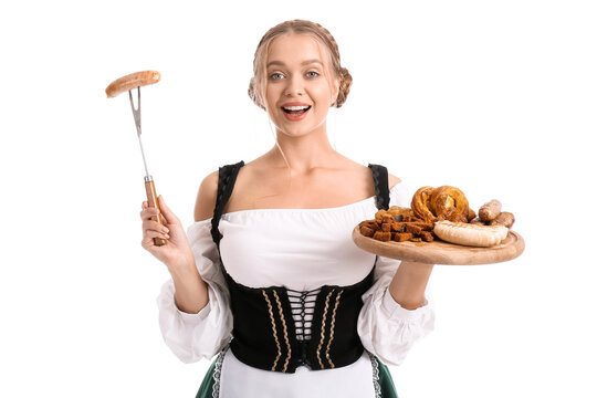 Beautiful woman in traditional German costume and with snacks on white background