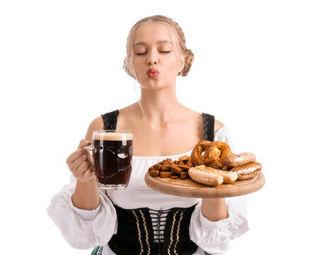 Beautiful woman in traditional German costume, with snacks and mug of beer on white background