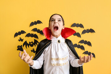 Cute little boy dressed as vampire for Halloween on color background - obrazy, fototapety, plakaty