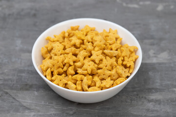sweet yellow corn flakes in white small bowl