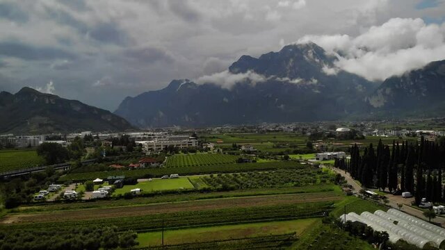 4K drone footage over village with mountains on the back in Arco, Italy.
Mid angle, traveling movement.