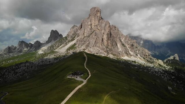 4K drone footage over mountain hut with mountain range on the back in Passo di Giau, Dolomites, Italy.
Mid angle, parallax movement.