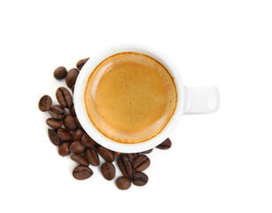 Cup of tasty espresso and scattered coffee beans on white background, top view