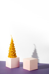Podiums and curly candle on a white background. Two cubic podium Christmas tree. Mockup for demonstrating cosmetic products.