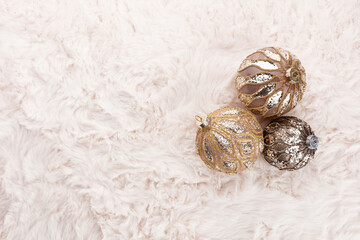 Golden christmas balls with wool background.