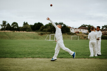 Cricket player catching a ball