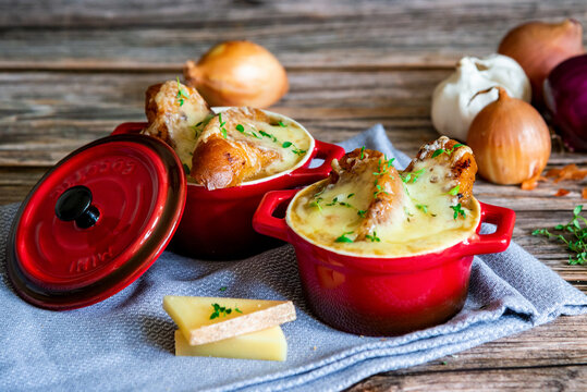 Home made traditional French onion soup served in small cocotte pots with cheese and toasts
