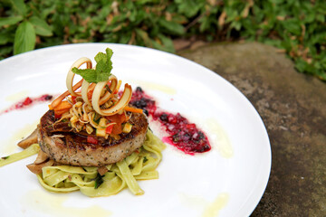 beef burger and green fettuccini at plate