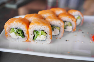 a set of Philadelphia rolls on a white plate. Japanese cuisine. 