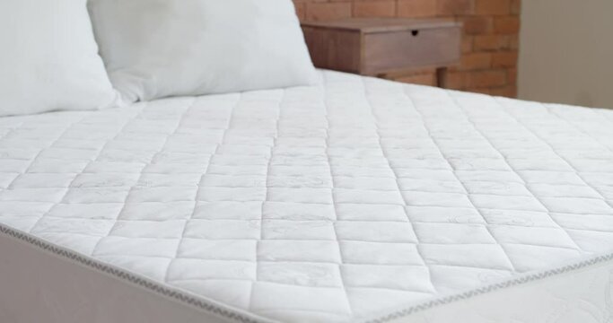 Bed with soft mattress in room, closeup