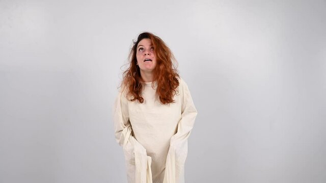 Close-up portrait of insane woman in straitjacket on white background.