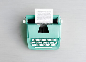 Retro pastel typewriter on grey surface