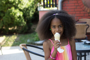 cute mixed girl eating an ice cream