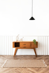 Pendant lamp over a wooden sideboard table