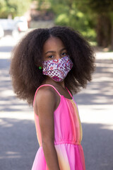 Portrait of a little multiracial girl wearing a medical mask	