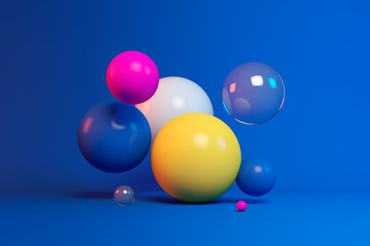 Three dimensional render of colorful spheres floating against blue background