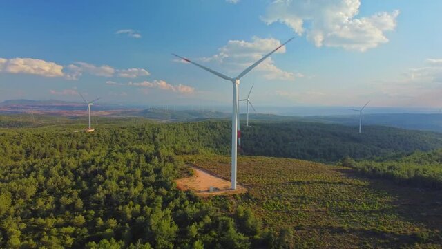 Drone Flies Over a Windmill Park . Aerial View of a Farm With Wind Turbines . Wind Power Turbines Generating Clean Renewable Energy for Sustainable Development. High quality 4k footage