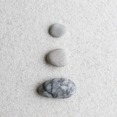 Fototapeta na wymiar Marble zen stones stacked on white background in stability concept