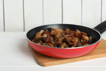 Tasty fried cracklings on white wooden table. Cooked pork lard