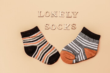 Day lost socks, lonely socks on a beige background.