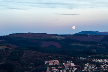 panoramic view of bilbao at sunset from mount malmasin with full moon
