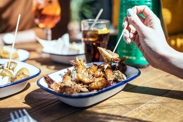 Woman having fried prawn in restaurant