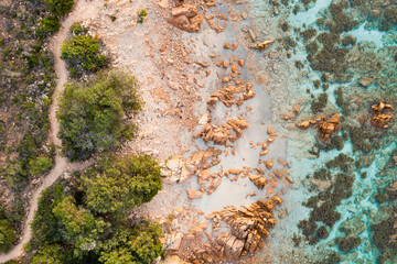View from above, stunning aerial view of a green and rocky coastline bathed by a turquoise, crystal clear water. Liscia Ruja,Sardinia, Italy..