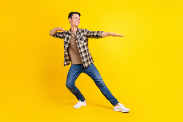 Fototapeta na wymiar Profile photo of crazy dancer guy enjoy disco wear checkered shirt jeans footwear isolated yellow color background