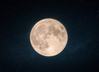 Beautiful yellow full moon with craters in the starry sky.