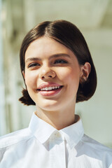 Happy teenager girl in white shirt in sunlight