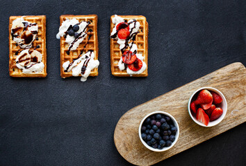 Waffles gofry with fruits on the dark backround