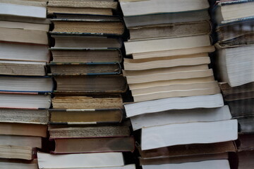 Empilement de livres anciens dans une vitrine de librairie.
